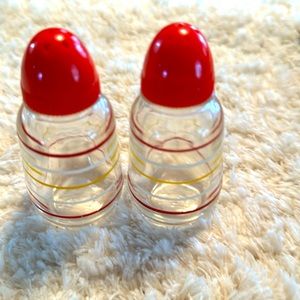 VINTAGE salt and pepper shakers. Clear with red white and yellow stripes.